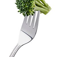 Broccoli on a fork isolated on white background and copy space by Pablo Romero