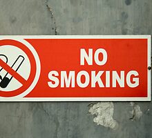No Smoking sign on an old wall by ashishagarwal74