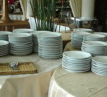 stack of white plates by bayu harsa