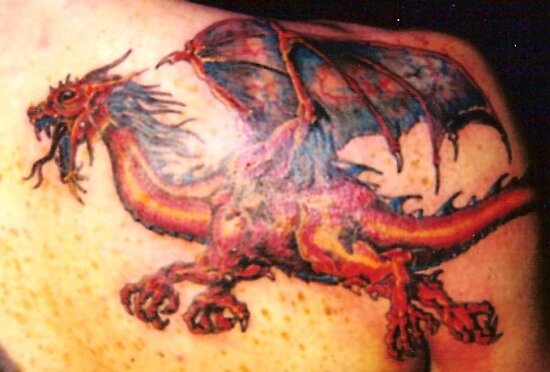 Red dragon tattoo on the back right shoulder. Red dragon tattoo on the back right shoulder.